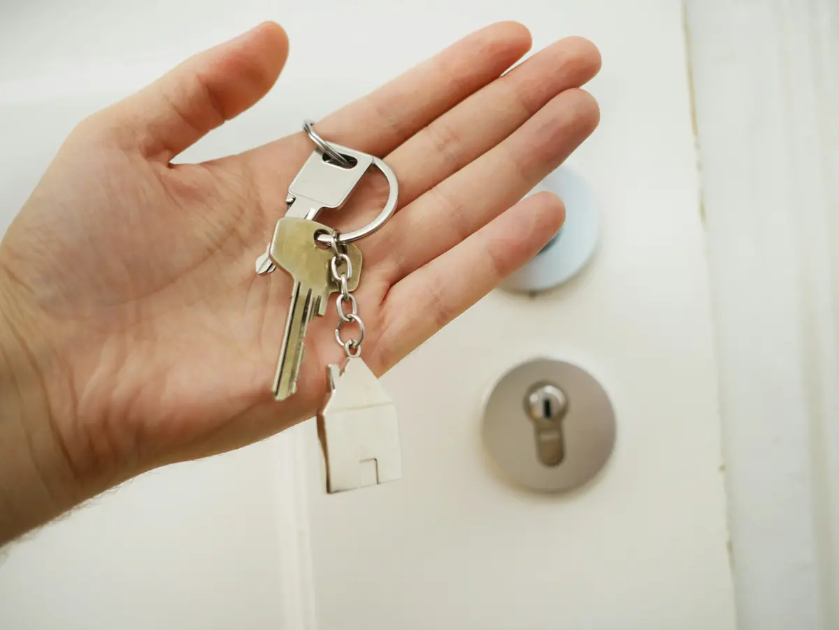 House keys handed over at the front door on moving day